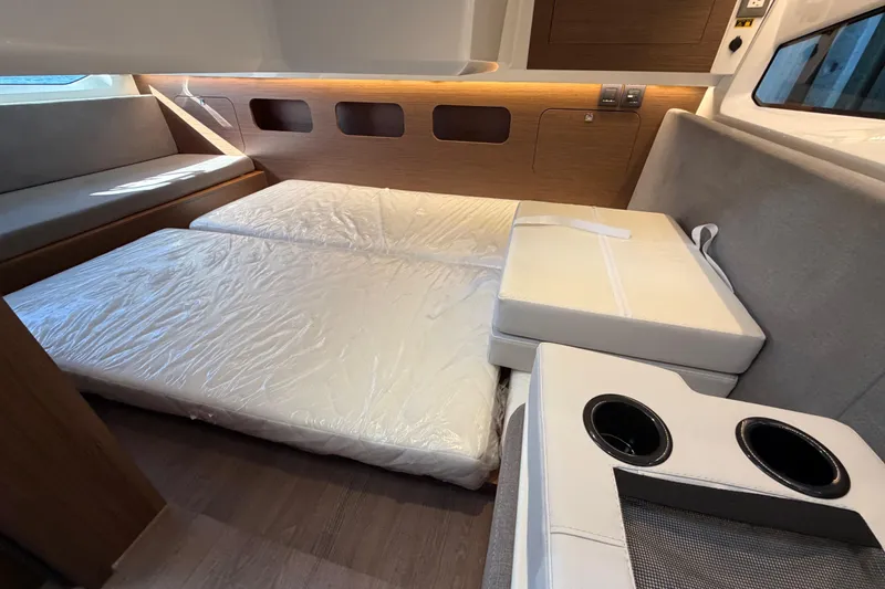 Slide: The Image of Interior cabin of 2026 Beneteau Antares 11 Fly with convertible seating and modern design. - 23