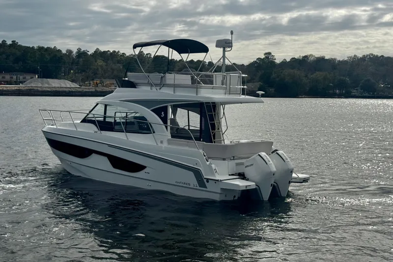 Slide: The Image of 2026 Beneteau Antares 11 Fly yacht cruising on a calm lake under cloudy skies. - 5