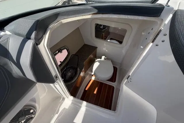Slide: The Image of 2013 Chaparral 277 SSX boat interior with compact bathroom and toilet. - 10