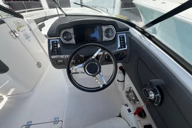 Slide: The Image of Interior cockpit of 2013 Chaparral 277 SSX boat, featuring steering wheel and dashboard controls. - 11