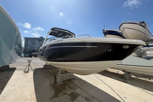 Slide: The Image of 2013 Chaparral 277 SSX boat on dry dock under clear blue sky. - 3