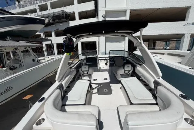 Slide: The Image of 2013 Chaparral 277 SSX boat interior with white seating and modern dashboard. - 6