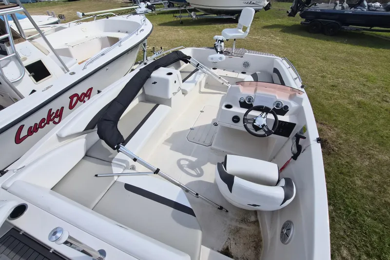 Slide: The Image of 2023 Starcraft SVX 171 OB boat interior with steering wheel and seating on display. - 4