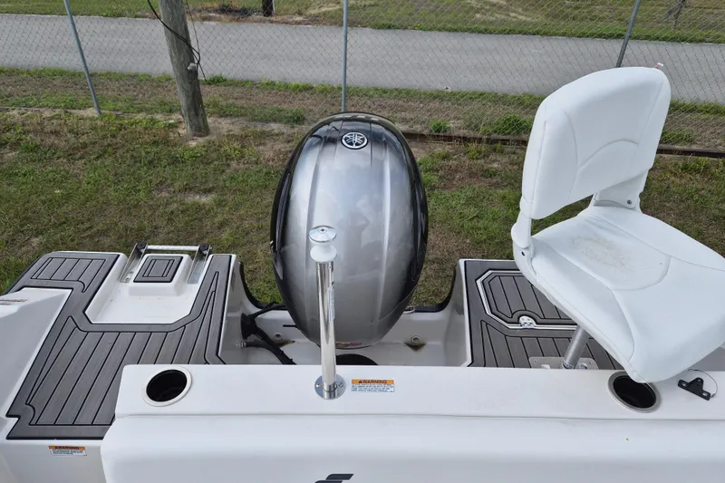 Slide: The Image of 2023 Starcraft SVX 171 OB boat with outboard motor and seating, docked on grass. - 5