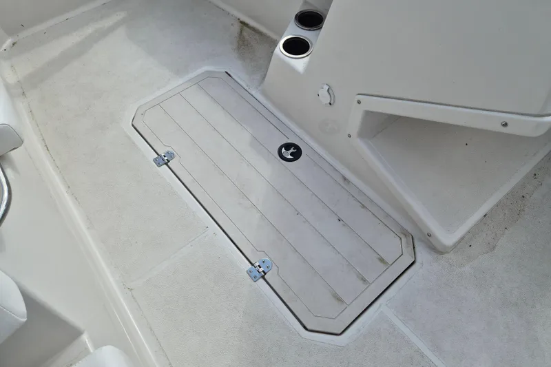 Slide: The Image of 2023 Starcraft SVX 171 OB boat interior with storage compartment and cup holders. - 9