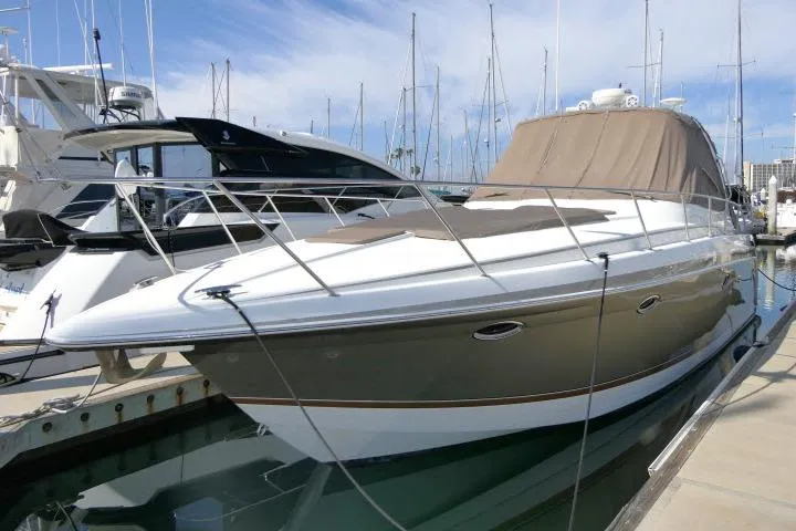 The Image of 2003 Thunderbird Formula 40PC yacht docked at marina under clear sky. - 1