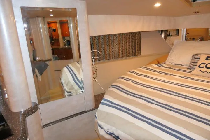 Slide: The Image of Interior of 2003 Thunderbird Formula 40PC yacht with striped bedding and modern decor. - 14