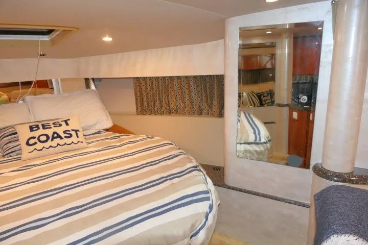 Slide: The Image of Interior of 2003 Thunderbird Formula 40PC yacht with striped bedding and "Best Coast" pillow. - 15