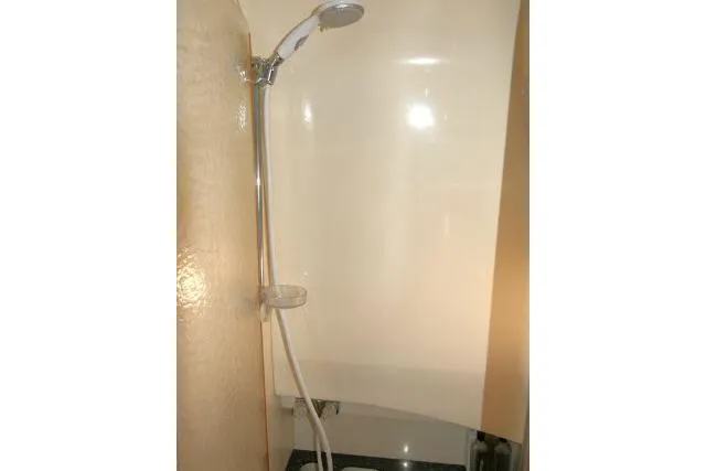 Slide: The Image of Shower area in 2003 Thunderbird Formula 40PC boat, featuring a handheld showerhead. - 18