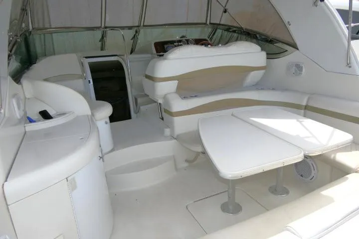 Slide: The Image of Interior of a 2003 Thunderbird Formula 40PC yacht with white seating and tables. - 24