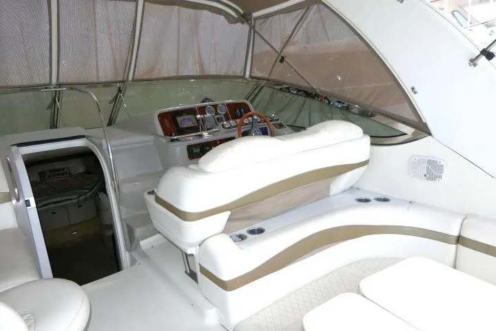 Slide: The Image of 2003 Thunderbird Formula 40PC yacht interior with white seating and control panel. - 25