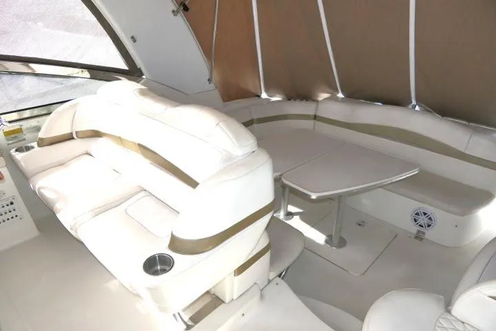 Slide: The Image of 2003 Thunderbird Formula 40PC yacht interior with white leather seating and dining table. - 26