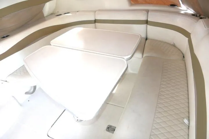 Slide: The Image of 2003 Thunderbird Formula 40PC interior with white seating and dual tables. - 28