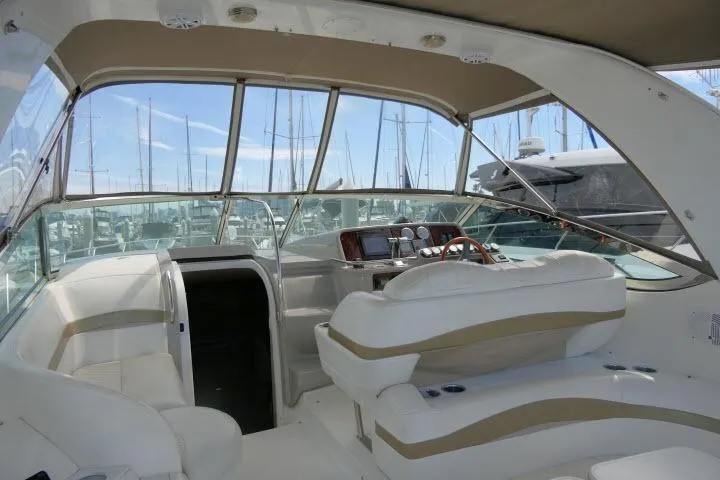 Slide: The Image of Interior view of a 2003 Thunderbird Formula 40PC yacht with white seating and dashboard. - 32