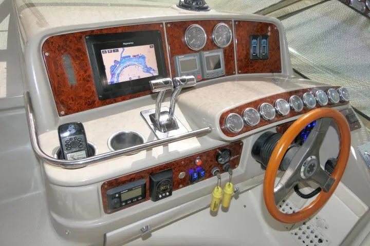 Slide: The Image of 2003 Thunderbird Formula 40PC yacht dashboard with navigation system and wooden steering wheel. - 36