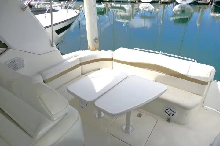 Slide: The Image of 2003 Thunderbird Formula 40PC yacht interior with white seating and table, docked at marina. - 38