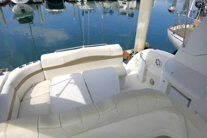Slide: The Image of 2003 Thunderbird Formula 40PC yacht interior with plush seating at marina. - 40