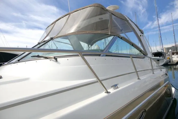 Slide: The Image of 2003 Thunderbird Formula 40PC yacht with sleek design, docked in marina under blue sky. - 42