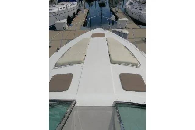 Slide: The Image of 2003 Thunderbird Formula 40PC yacht bow with sun pads at marina. - 43