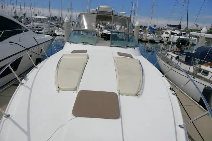 Slide: The Image of 2003 Thunderbird Formula 40PC yacht docked at marina, featuring spacious deck and sun pads. - 45