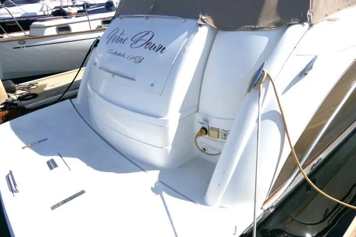 Slide: The Image of 2003 Thunderbird Formula 40PC yacht docked, featuring sleek design and elegant lettering on the stern. - 49