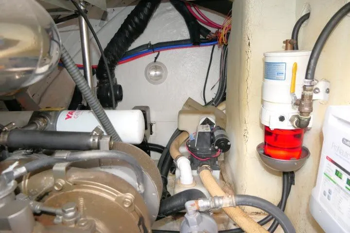Slide: The Image of Engine room of a 2003 Thunderbird Formula 40PC boat, showcasing mechanical components and wiring. - 50