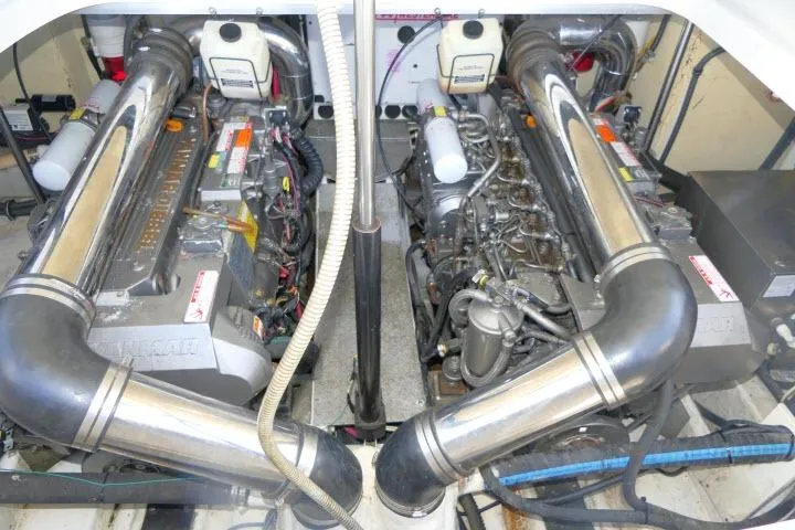 Slide: The Image of Engine room of a 2003 Thunderbird Formula 40PC boat, showcasing dual engines and exhaust systems. - 52