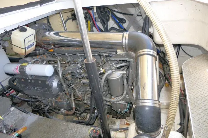 Slide: The Image of Engine compartment of a 2003 Thunderbird Formula 40PC boat, showcasing mechanical components and piping. - 54