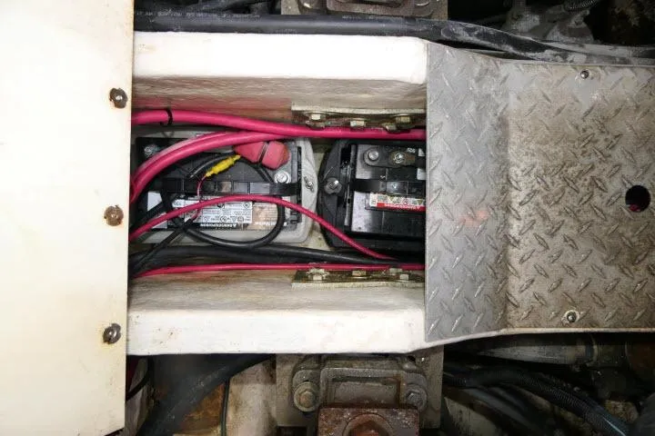 Slide: The Image of Battery compartment of a 2003 Thunderbird Formula 40PC with visible wiring and metal cover. - 55