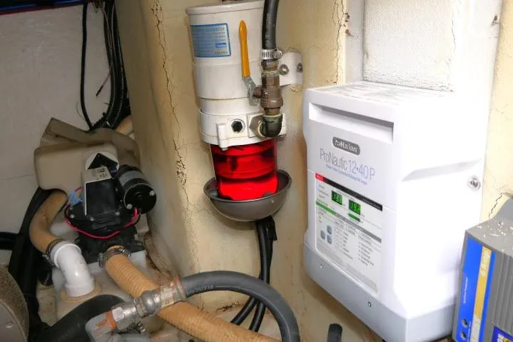 Slide: The Image of Engine compartment of 2003 Thunderbird Formula 40PC with ProNautic 1240P charger and fuel filter system. - 56