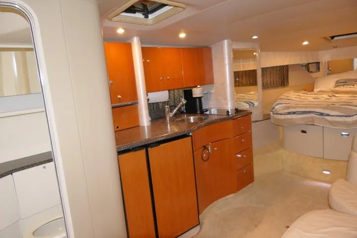 Slide: The Image of Interior of 2003 Thunderbird Formula 40PC yacht with modern kitchen and cozy sleeping area. - 8