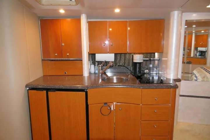 Slide: The Image of 2003 Thunderbird Formula 40PC yacht kitchen with wooden cabinets and modern appliances. - 9