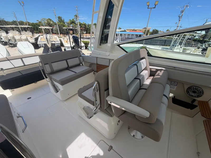 Slide: The Image of The 2027 Boston Whaler 330 Vantage features a spacious cabin with comfortable seating and modern design. - 17
