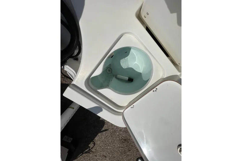 Slide: The Image of Livewell compartment on a 2023 Sea Pro 208 Bay boat, open and empty. - 10