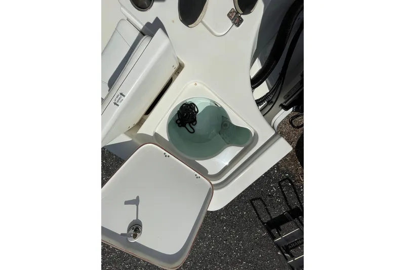 Slide: The Image of 2023 Sea Pro 208 Bay boat interior storage compartment with open lid. - 11