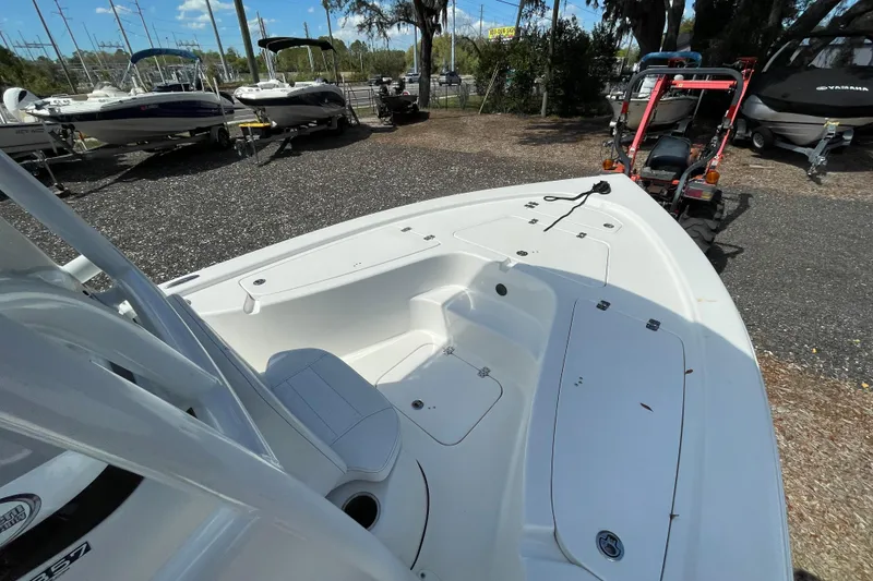 Slide: The Image of 2023 Sea Pro 208 Bay boat on display at a dealership lot. - 7