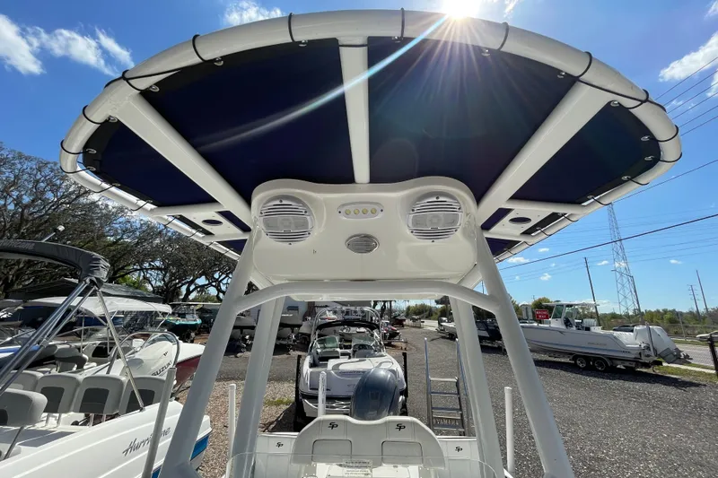 Slide: The Image of 2023 Sea Pro 208 Bay boat with T-top and speakers under sunny sky. - 9