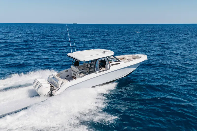 The Image of 2021 Boston Whaler 350 Realm cruising on open blue ocean waters. - 0