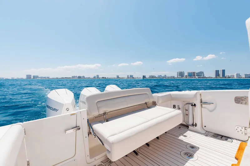 Slide: The Image of 2021 Boston Whaler 350 Realm boat interior with helm, ocean view, and clear blue sky. - 11