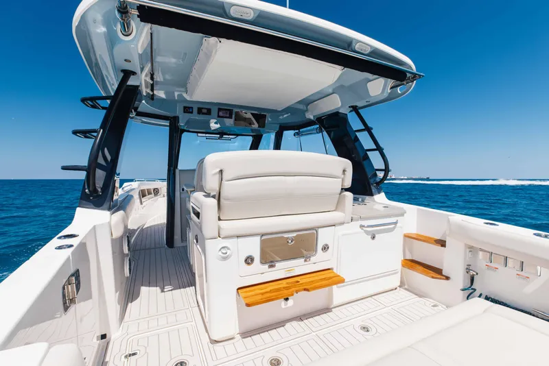 Slide: The Image of Engine compartment of 2021 Boston Whaler 350 Realm, showcasing mechanical components and storage. - 15