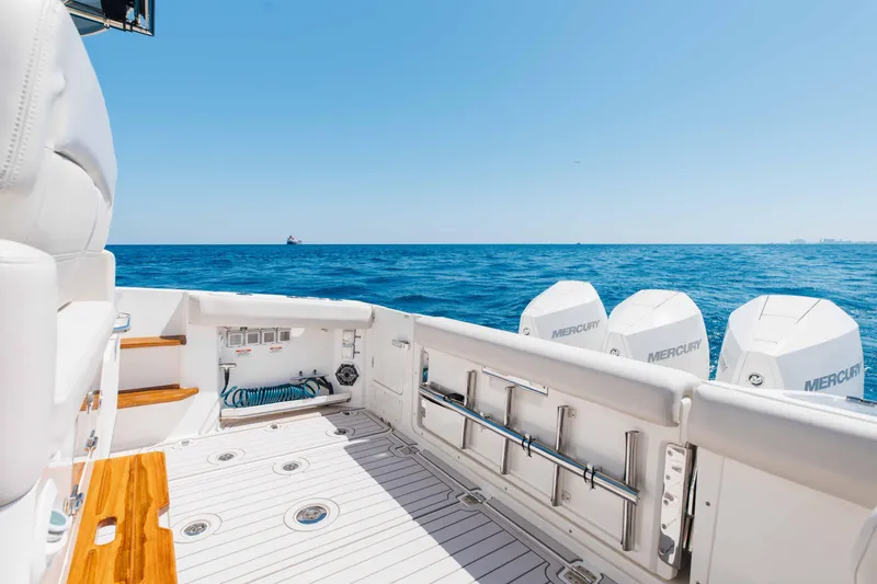 Slide: The Image of 2021 Boston Whaler 350 Realm cruising on open water with city skyline in background. - 17