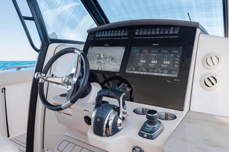 Slide: The Image of 2021 Boston Whaler 350 Realm interior with ocean view and luxurious seating. - 24