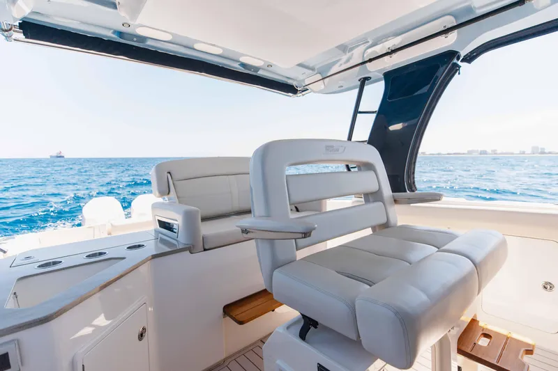 Slide: The Image of 2021 Boston Whaler 350 Realm boat interior with ocean view and distant ships. - 27