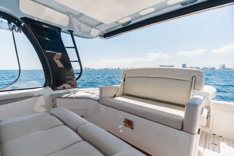 Slide: The Image of Luxurious interior of 2021 Boston Whaler 350 Realm with white seating and mounted TV. - 29