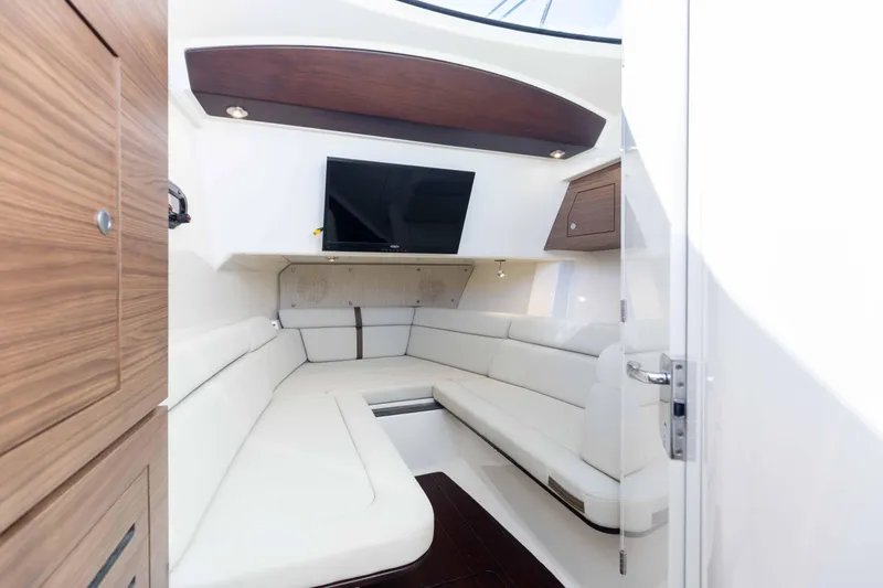 Slide: The Image of Interior of 2021 Boston Whaler 350 Realm, featuring sleek seating and modern cabinetry. - 31