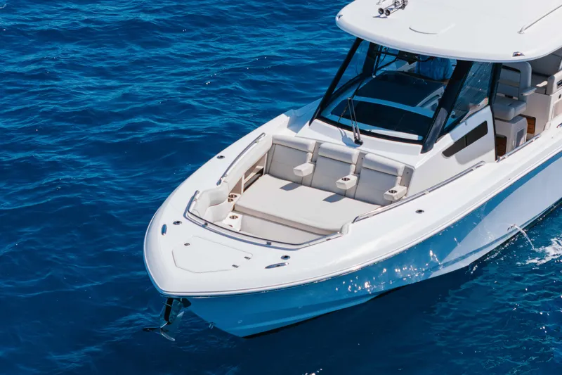 Slide: The Image of 2021 Boston Whaler 350 Realm cruising on open blue ocean waters. - 7