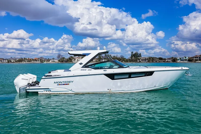 Slide: The Image of 2023 Monterey 350 Sport Yacht cruising on clear blue water under a vibrant sky. - 1