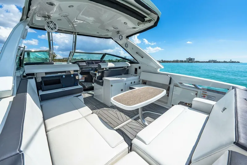 Slide: The Image of Luxurious 2023 Monterey 350 Sport Yacht interior with seating, table, and ocean view. - 10