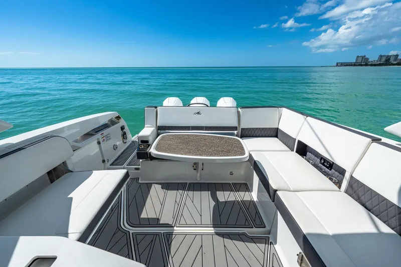 Slide: The Image of 2023 Monterey 350 Sport Yacht interior with ocean view, featuring luxurious seating and sleek design. - 11