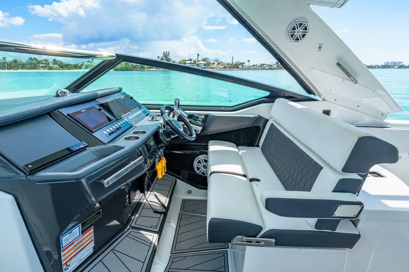 Slide: The Image of Cockpit of 2023 Monterey 350 Sport Yacht with modern controls and seating. - 15